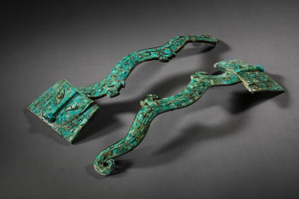 A pair of Chinese Warring States period copper inlaid turquoise belt hooks
