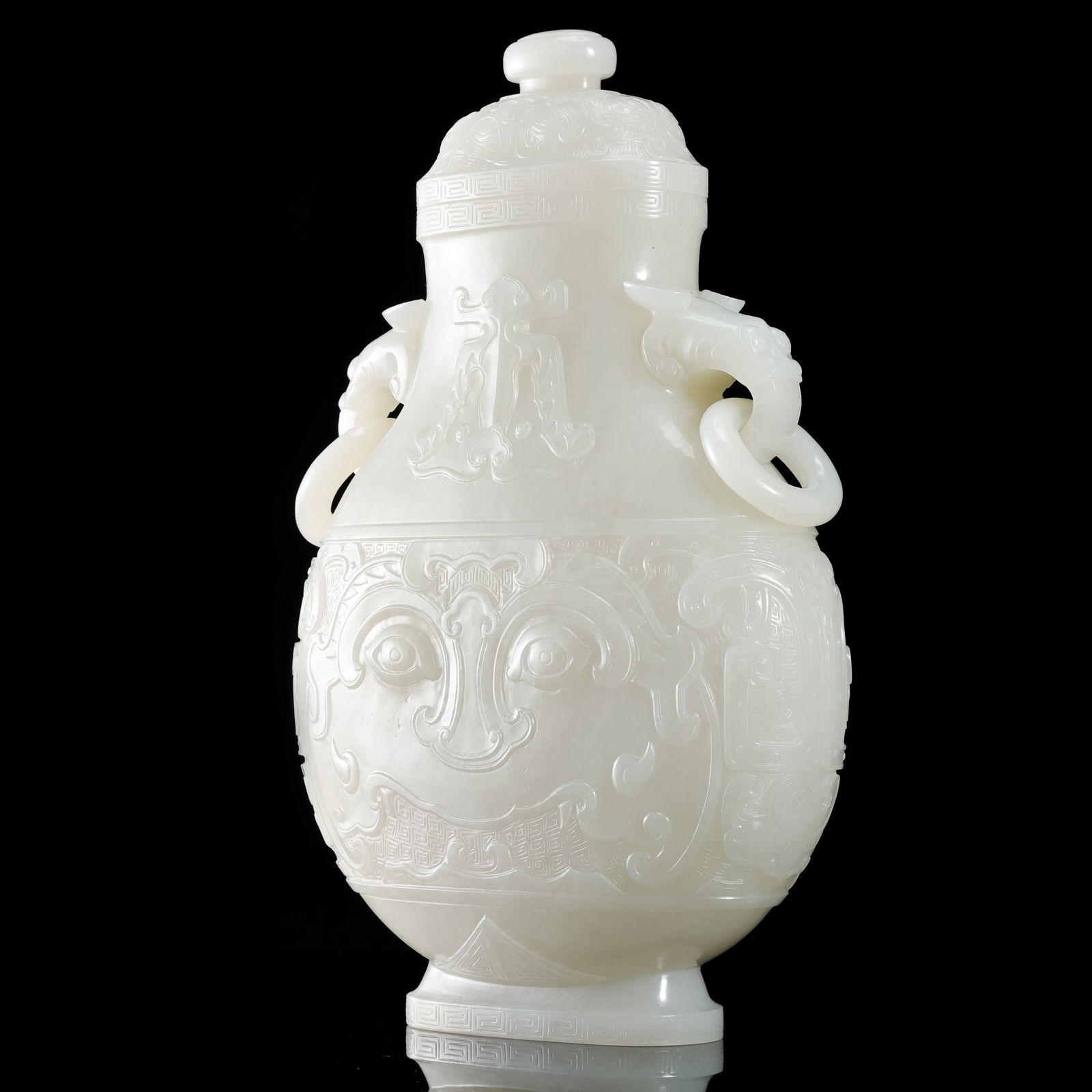 QING DYNASTY WHITE NEPHRITE FLASK WITH DOUBLE-RINGED EARS AND ANIMAL-FACE PATTERNS: H. 23 cm. W. 14.5 cm. Weight 1315 gram.