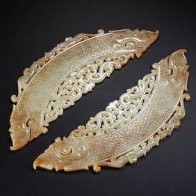 A pair of Chinese Han Dynasty jade pendants with double dragon heads