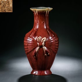 A Chinese red-glazed vase with a butterfly pattern, Qianlong period of the Qing Dynasty