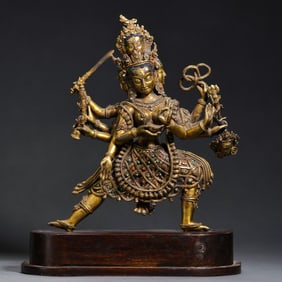 A Chinese gilt bronze statue of a standing Buddha inlaid with gemstones, Qing Dynasty