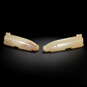 A PAIR OF JADE PIGS FROM THE HAN DYNASTY (1ST TO 3RD CENTURIES)