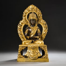 A CHINESE GILT BRONZE STATUE OF A SEATED BUDDHA FROM THE QIANLONG PERIOD OF THE QING DYNASTY