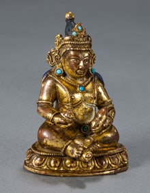 A CHINESE QING DYNASTY GILT BRONZE AND TURQUOISE SEATED STATUE OF THE GOD OF WEALTH