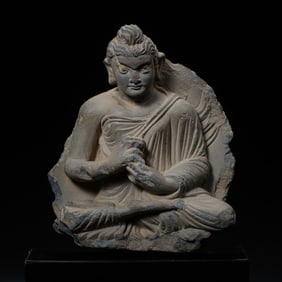 A 2ND CENTURY GANDHARA BLUESTONE STATUE OF A SEATED BUDDHA