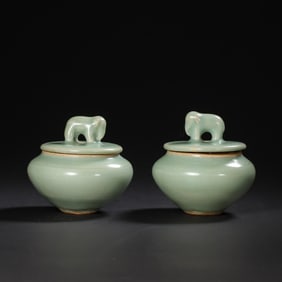 A PAIR OF CHINESE SOUTHERN SONG DYNASTY LONGQUAN KILN GREEN GLAZE ELEPHANT-SHAPED LIDDED JARS