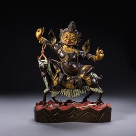 A PARTIALLY GILDED BRONZE STATUE OF A BUDDHA FROM THE QIANLONG PERIOD OF THE QING DYNASTY