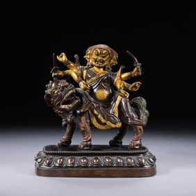 A PARTIALLY GILDED BRONZE STATUE OF A BUDDHA FROM THE QIANLONG PERIOD OF THE QING DYNASTY