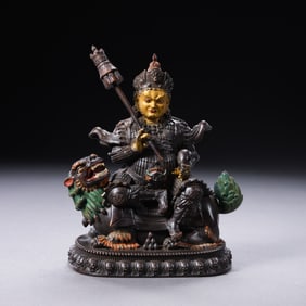 A PARTIALLY GILDED BRONZE STATUE OF A BUDDHA FROM THE QIANLONG PERIOD OF THE QING DYNASTY