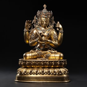 MING DYNASTY. A GILT-BRONZE FIGURE OF A SEATED BUDDHA INLAID WITH GEMS