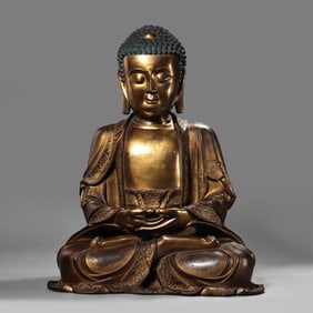 MING DYNASTY. GILT-BRONZE FIGURE OF A SEATED BUDDHA.