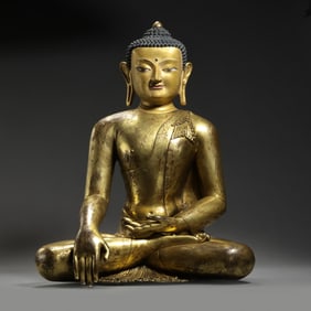 MING DYNASTY. GILT-BRONZE FIGURE OF A SEATED BUDDHA.