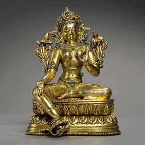 QING DYNASTY A GILT-BRONZE FIGURE OF A SEATED BUDDHA INLAID WITH GEMS