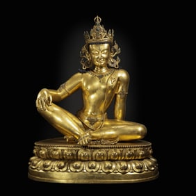 QING DYNASTY A GILT-BRONZE FIGURE OF A SEATED BUDDHA INLAID WITH GEMS