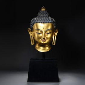 MING DYNASTY. GILT-BRONZE BUDDHA HEAD
