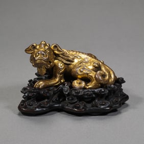 QING DYNASTY A GILT-BRONZE STATUE OF AUSPICIOUS BEASTS
