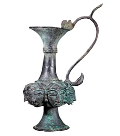 Ancient Persian bronze pot with human face and phoenix handle
