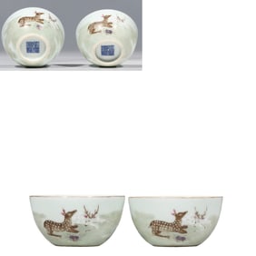A pair of Chinese Qing dynasty Qianlong period famille rose cups with double deer designs