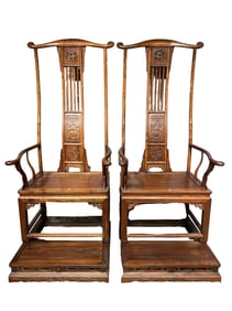 A pair of Chinese Qing Dynasty Huanghuali wood armchairs