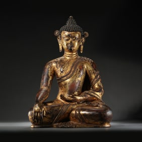 A Chinese Ming Dynasty gilt bronze statue of a seated Buddha