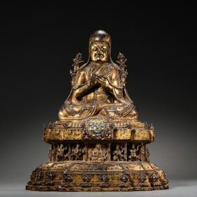 A Chinese Ming Dynasty gilt bronze statue of a seated Buddha