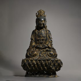 A Chinese Ming Dynasty gilt bronze statue of a seated Buddha