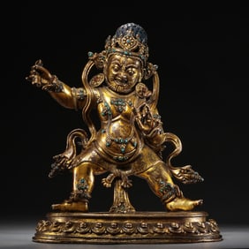 A Chinese Qing Dynasty gilt bronze statue of the God of Wealth inlaid with gemstones
