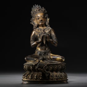 A Chinese Ming Dynasty gilt bronze statue of a seated Buddha