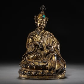 A Chinese Ming Dynasty gilt bronze statue of Guru Padmasambhava
