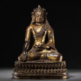 A Chinese Qing Dynasty gilt bronze statue of a seated Buddha