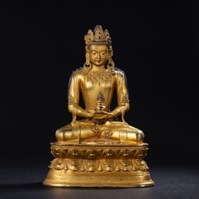 A Chinese Ming Dynasty gilt bronze statue of a seated Buddha