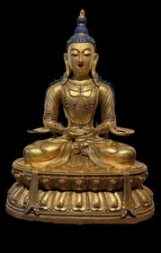 A Chinese Ming Dynasty gilt bronze statue of a seated Buddha