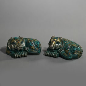 A pair of gold and silver inlaid auspicious beasts from the Warring States Period of China