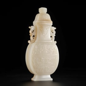 Chinese Qing Dynasty Hetian jade double-eared covered vase with animal face pattern