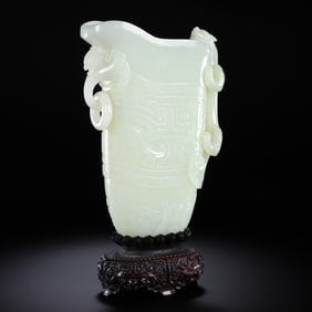 A Chinese Qing Dynasty Hetian white jade goblet with ring ears and animal-faced patterns and a