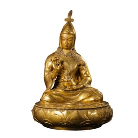 A Chinese Qing Dynasty gilt bronze statue of a seated Tibetan Buddhist