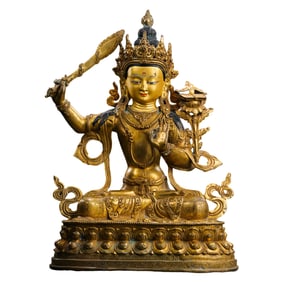 A Chinese Qing Dynasty gilt bronze statue of a seated Buddha