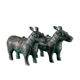A pair of gold and silver inlaid auspicious beasts from the Warring States Period of China