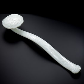 A Chinese Qing Dynasty Hetian white jade carved Ruyi ornament