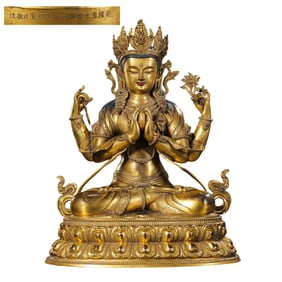 A Chinese gilt bronze four-armed seated Guanyin statue from the Qianlong period of the Qing Dynasty