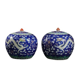 A pair of Chinese Qing Dynasty famille rose jars with dragon patterns and lids