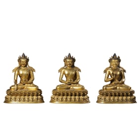 A group of Chinese Ming Dynasty gilt-bronze statues of the Three Buddhas