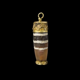 TIBETAN AGATE BEAD MOUNTED IN GOLD