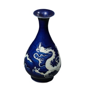 A Chinese Yuan Dynasty blue-glazed jade vase with white dragon pattern