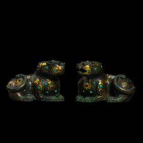 A pair of auspicious beasts inlaid with gold, silver and gemstones from the Warring States Period of