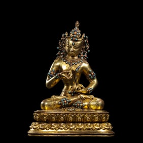 A Chinese Qing Dynasty gilt bronze statue of a seated Buddha inlaid with gemstones