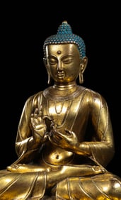 A Chinese Ming Dynasty gilt bronze statue of a seated Buddha