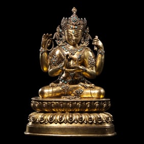 A Chinese Ming Dynasty gilt-bronze seated Buddha statue inlaid with gemstones