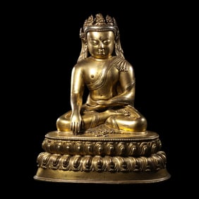 A Chinese Ming Dynasty gilt bronze statue of a seated Buddha