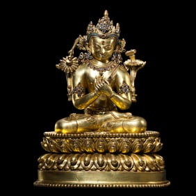 A Chinese Ming Dynasty gilt-bronze seated Buddha statue inlaid with gemstones